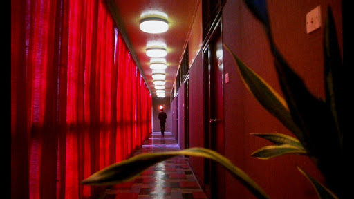 Long red hallway film setting